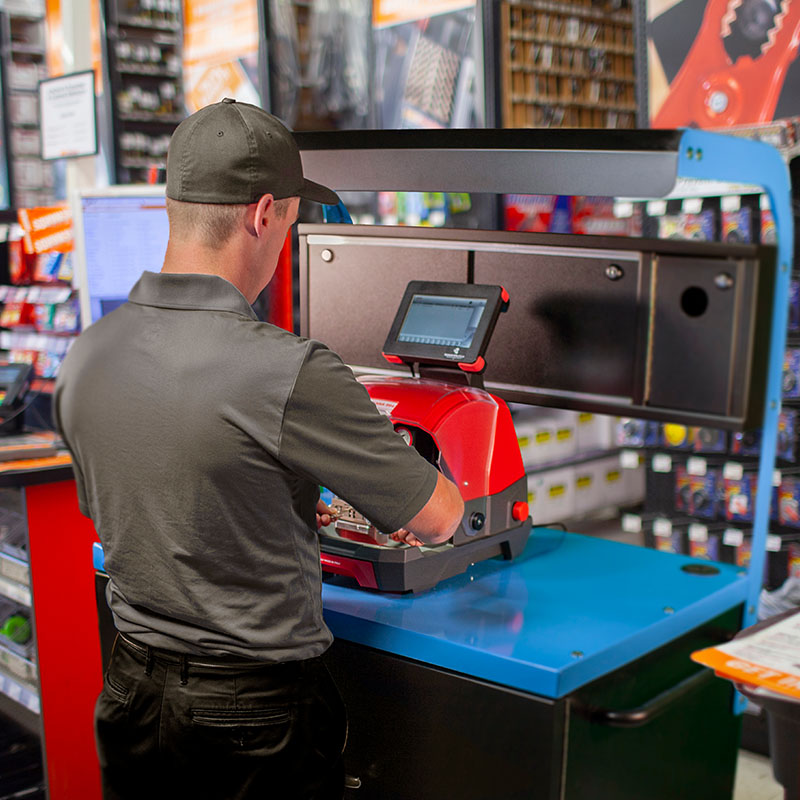 Retail employee using CKE key cutting program